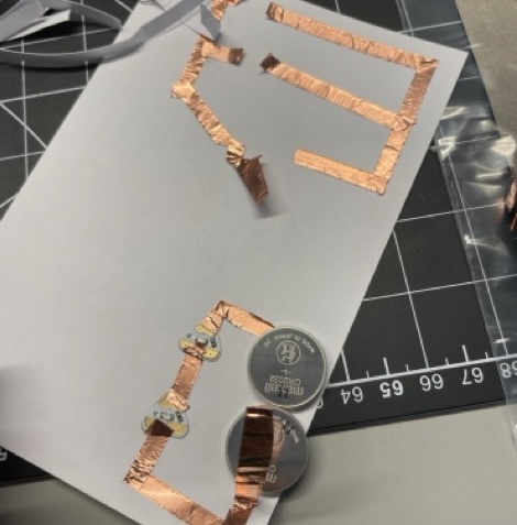 The paper that I did my first three circuts on. The inital single circut got turned into the paralell circuit and I reused the lights and batteries.