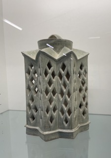 a ceramic form that is reminicent of a lantern. This object is found beside the printmaking studio before the ceramic studio This material is used by the ceramic program at sheridan