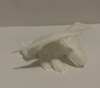 This is the 3D print of the toothless minifigure I modeled based off of a real one that I have. I extruded any printed details such as the eyes and a horned skull on the tail although the size of the print means they are not immediately readable shapes. The print is intentionally in a low polygon-esq style to contrast the next print's roundness and sculpted look. <div class='container2'> <img
                         src='images/final/D2.jpeg' </div> <div class='container2'><img src='images/final/D3.jpeg' </div>